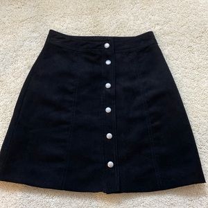 H&M black suede skirt with silver snap buttons in front. Size: Xsmall.